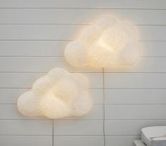 two white clouds are on the wall next to each other