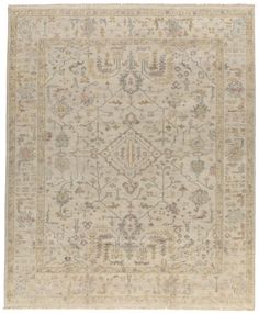 an antique rug with many different colors and patterns on the carpet, including beiges and browns