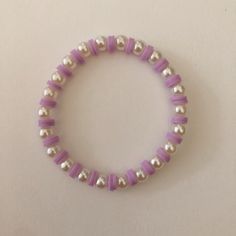 Cute pearl beaded bracelet with purple polymer clay beads. (Disclaimer: not real pearls) Clay Beads Bracelet Ideas With Pearls, Beaded Purple Bracelets, Polymer Beads Bracelet, Clay Bead Bracelet Ideas Aesthetic Purple, Clay Bracelet Ideas Purple, Bracelets Of Beads, Handmade Jewelry Ideas Bracelets, Purple Bracelet Ideas Clay Beads, Polymer Clay Beads Bracelet