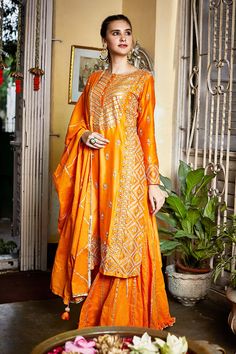 Orange straight kurta with embroidered floral motifs and side slits. Comes with sharara and dupatta.
Component: 3
Embroidery
Neckine: Round
Sleeve Length: Bracelet
Fabric: Silk Chanderi, Organic Cotton
Color: Orange
Hand embroidery
Zari trim detail on pant
Ruffle detail on pant hem
Zari trim detail on dupatta with tassel detail on hem
Closure: Concealed front hook placket on kurta - Aza Fashions Orange Sharara, Embroidered Sharara, Sharara Pants, Pink City, Sharara Set, Indian Fashion Designers, Pernia Pop Up Shop, Modern Branding, Embroidered Silk