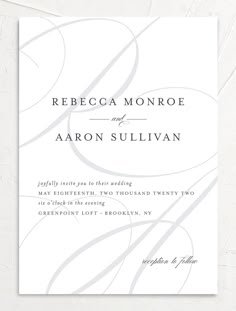 an elegant white wedding card with swirls on the front and back, in black ink