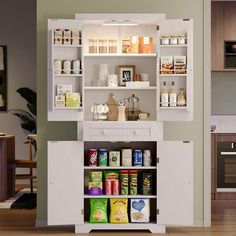 an open cabinet in the middle of a kitchen with lots of food on top of it