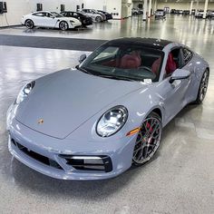 a silver sports car parked in a garage