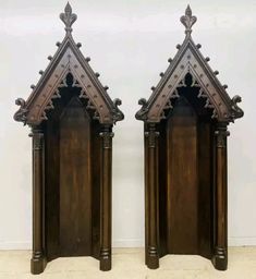 pair of carved wooden doors in the shape of gothic architecture