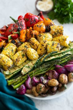 grilled vegetables are arranged on a white plate