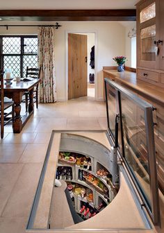 a kitchen with a hole in the floor that is filled with food