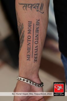 a man with a tattoo on his arm holding onto another person's hand and the words written in different languages