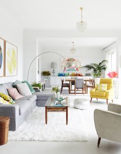 a living room filled with furniture and lots of white furnishing on the floor