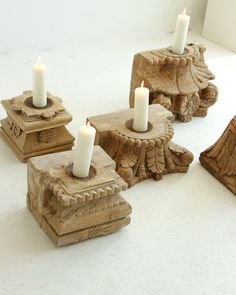 four candles sitting on top of wooden blocks