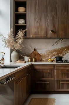 a kitchen with wooden cabinets and marble counter tops