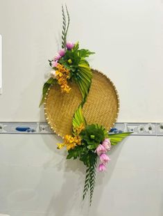 two straw hats with flowers on the wall