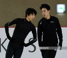 two young men skating on an ice rink