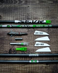 several different types of pens and markers laid out on a wooden surface