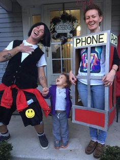 two women and a child are dressed up as phone booths