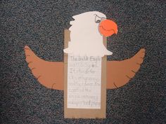 an eagle made out of paper on a bulletin board