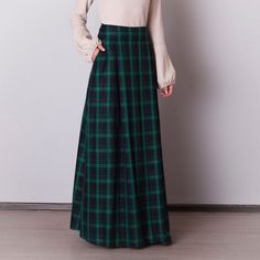 Black and green plaid skirt: - Side seam pockets - Hidden zipper on the back - Lined belted part - Classic tartan pattern - Fabric is 40% wool, 58% polyviscose, 2% of elastane Model is 6'2'', she wears US 8 size US 0  Bust 82 cm (32.5 inches) Waist 64 cm (25 inches) Hips 89 cm (35 inches) US 2  Bust 85 cm (33.5 inches) Waist 66 cm (26 inches) Hips 92 cm (36 inches) US 4  Bust 88 cm (34.5 inches) Waist 68 cm (27 inches) Hips 94 cm (37 inches)  US 6  Bust 90 cm (35.5 inches) Waist 71 cm (28 inches) Hips 96 cm (38 inches)  US 8  Bust 93 cm (36.5 inches) Waist 74 cm (29 inches) Hips 99 cm (39 inches) US 10  Bust 95 cm (37.5 inches) Waist 76 cm (30 inches) Hips 102 cm (40 inches) US 12  Bust 99 cm (39 inches) Waist 80 cm (31.5 inches) Hips 105 cm (41.5 inches) US 14  Bust 103 cm (40.5 inches) W Green Long Skirt Bottoms For Fall, Green Lined Maxi Skirt For Fall, Green Pleated Skirt For Fall, Green Long Skirt For Fall, Green Pleated Maxi Skirt For Fall, Fall Green Lined Maxi Skirt, Green Lined Skirt For Fall, Green Maxi Skirt For Winter, Green Winter Maxi Skirt