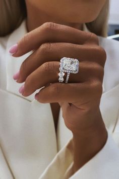 a close up of a person wearing a diamond ring