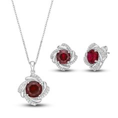 This radiant boxed set features a matching necklace and pair of earrings set in classic sterling silver. Each piece showcases a round-cut lab-created ruby surrounded by a dazzling frame of white lab-created sapphires. The pendant hangs from an 18-inch cable chain and secures with a lobster clasp.