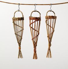 three woven objects hanging from a clothes line