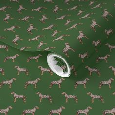 a green wallpaper with brown and white dogs on it's sides, in the middle