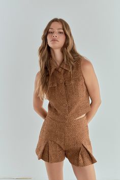 Step up your style game with our must-have Tweed Short Sleeveless Jacket! Made with high-quality tweed fabric, this jacket offers a trendy cropped length and sleek collar for an effortless polished look. Perfect for layering or dressing up any outfit, this jacket also includes front pockets for added functionality. Elevate your wardrobe with this versatile and on-trend piece that will keep you looking chic and cozy all day long. Shop now and add this stunning Tweed Short Sleeveless Jacket to you Chic Tweed Tops For Fall, Chic Brown Cropped Jacket, Chic Cropped Tweed Jacket, Chic Cropped Vest For Workwear, Chic Cropped Vest For Work, Chic Cropped Tweed Outerwear, Chic Brown Tweed Jacket, Knitwear Trends, Knit Loungewear