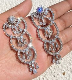 Diamond  Earrings featuring semi precious cubic zirconia and diamonds. Ideal to pair with your india western sarees and formal outfits. These earrings chendelier design will elevate your look. Perfect gift for her and gift for sister. *𝐏𝐑𝐎𝐃𝐔𝐂𝐓 𝐃𝐄𝐓𝐀𝐈𝐋* * 𝐌𝐚𝐭𝐞𝐫𝐢𝐚𝐥: Brass * 𝐏𝐥𝐚𝐭𝐢𝐧𝐠: White Rhodium Plated * 𝐒𝐭𝐨𝐧𝐞: AAA-quality CZ Diamond. *𝐃𝐈𝐌𝐄𝐍𝐒𝐈𝐎𝐍𝐒* * 𝐖𝐞𝐢𝐠𝐡𝐭: 13 gm each * 𝐂𝐥𝐨𝐬𝐮𝐫𝐞: Push Back 𝐕𝐢𝐬𝐢𝐭 𝐎𝐮𝐫 𝐅𝐀𝐐𝐬 𝐟𝐨𝐫 𝐒𝐡𝐢𝐩𝐩𝐢𝐧𝐠 𝐏? Western Sarees, White Sapphire Earrings, Zircon Earrings, Formal Outfits, Chandelier Design, Wedding Jewelry Earrings, Sapphire Earrings, Earrings Long, American Diamond