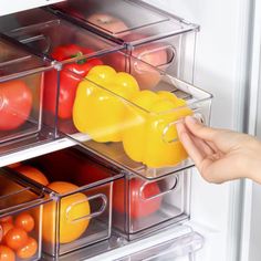 a refrigerator door is open with plastic containers filled with fruits and vegetables