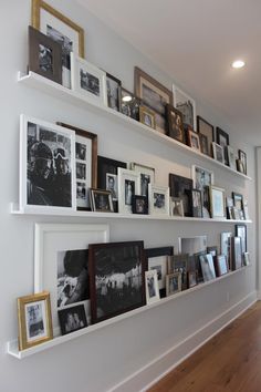 the wall is filled with pictures and frames