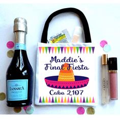 personalized tote bag with bottle and confetti on white surface surrounded by confetti