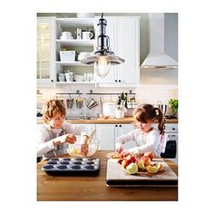 two children in the kitchen preparing food together