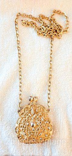 "Vintage Goldette Chatelaine Coin Purse Long Drop Gold plated. Pendant 2.75. Tall x 1.5\" wide. The plating looks perfect.  It was cast with a very ornate raised design.  Closes tightly.  Chain is in beautiful condition and the clap works well In excellent vintage condition. Please see our original photographs and use them as an extension of our written description. We sell select vintage items. They are not new, and rarely look new. They are, in many cases, older than we are.  They have seen li Luxury Gold Classic Coin Purse, Elegant Gold Locket Necklace, Elegant Gold Locket Necklace With Lobster Clasp, Formal Gold-tone Locket Necklace, Victorian Gold Locket Necklace, Victorian Gold Metal Locket Necklace, Gold Engraved Necklaces For Evening, Victorian Style Gold Metal Locket Necklace, Gold Engraved Necklace For Evening