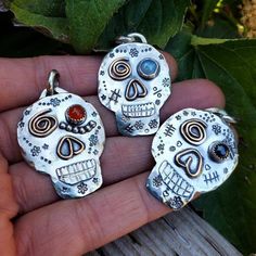 "Sweet silly Sugar skulls sending love and happiness your way.  These are made by hand with love in the spirit of Halloween and \"Dia De Los Muertos\"... holiday for celebrating the past lives of those before us.  Each skull is intricately hand sewn in sterling silver, stamped and decorated with 14kt Gold filled accents and a gemstone is set. Orange is Carnelian 5mm,  Bluish stone is Moonstone 6mm and Black is Onyx 5mm.  Your choice.  They make great gifts for novelty lovers and layer nicely with a beaded necklace... I get lot's of complements and they make your friends smile! These are created with great joy, love and good energy.. for you to feel! These are made here in my Bend, Oregon studio ready to ship ... You will recieve what you see in this photo.. unless it is sold and I have to Sugar Skull Necklace, Art Clay Silver, Halloween Pendant, Past Lives, Orange Stone, Sending Love, Love And Happiness, Skull Necklace, Sugar Skulls