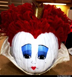 a white pumpkin with red hair and blue eyes