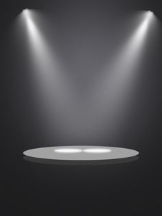 an empty stage with three spotlights on it