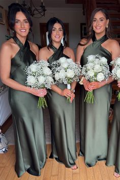 the bridesmaids are holding their bouquets and posing for a photo in green dresses