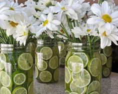 four mason jars filled with lemon slices and daisies are shown on the instagram page