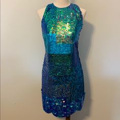 New With Tags! Gorgeous Tfnc London Dress Mermaid Size 4. Blue/Green Shiny Sequins On Sheer Material With Solid Blue Liner Layer Underneath. High Neck, Back Cutout With Button Loop Closure At The Back Top Neck. A Few Areas Have Missing Sequins, Can Be Repaired With Replacement Sequins. Not Noticeable If Not Repaired With Sequins. But Will Need Threads Tied Off To Prevent More Coming Off. Selling As Is. Hidden Side Zipper With Hook And Eye Closure. Scalloped Hem With Clam Like Sequins. Red Lace Bodycon Dress, Blue Liner, Mock Neck Mini Dress, Deep V Dress, London Dress, Dress Mermaid, Beaded Cocktail Dress, Lace Bodycon, Lace Bodycon Dress