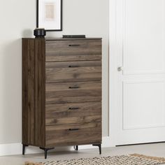 a brown chest of drawers sitting on top of a rug