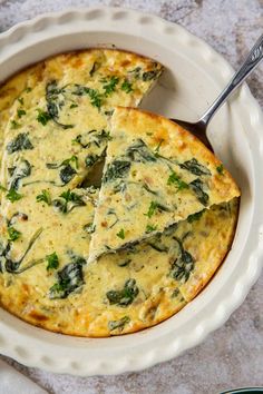 an omelet with spinach and cheese in a white bowl