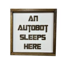 an autobot sleeps here sign in a wooden frame on a white background with the words'an autobot sleeps here '