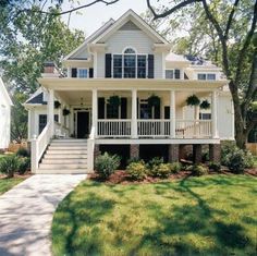 a large white house with porches and stairs