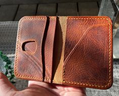 Handmade, minimalist pocket wallet with a beautiful caramel-like pull-up effect that's slim-lined and ages beautifully over time. We use full-grain Italian vegetable-tanned pull-up leather in the colour cognac from the Badalassi Carlo tannery in San Miniato, Tuscany. Features: - Four card slots capable of holding 1-2 cards each - Convenient quick-access pocket (Right) - Card slot with thumb window for easier access (Left) - Handstitched with polyester thread - OPTIONAL embossing of up to 3 initi Brown Leather Wallet With Flat Pocket, Cognac Trifold Wallet With Card Slots For Everyday Use, Brown Trifold Wallet With Smooth Grain For Everyday Use, Brown Leather Lined Card Holder For Daily Use, Brown Leather-lined Card Holder For Daily Use, Brown Leather-lined Card Holder For Everyday Use, Everyday Brown Trifold Wallet With Smooth Grain, Brown Leather Lined Card Holder, Leathercraft Projects