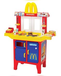 a child's play kitchen set with a mcdonalds sign on the top shelf