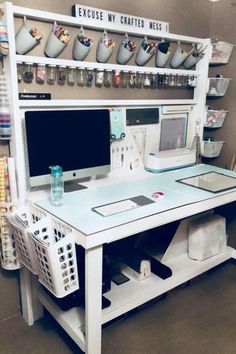 a white desk with two computers on it