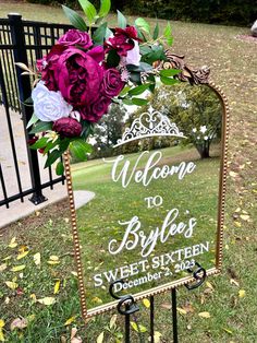 a welcome to bride's sign in front of a gate with flowers on it