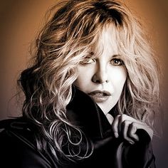 a black and white photo of a woman wearing a leather jacket with her hand on her shoulder