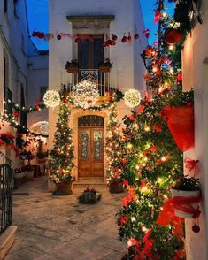 christmas decorations adorn the entrance to an old building