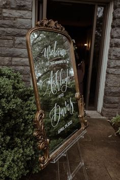 a sign that says welcome to the bride and groom in front of a brick building