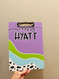 a hand holding up a clipboard with the words miss hyatt on it