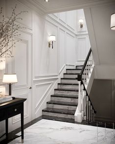 an elegant staircase with marble floors and white walls